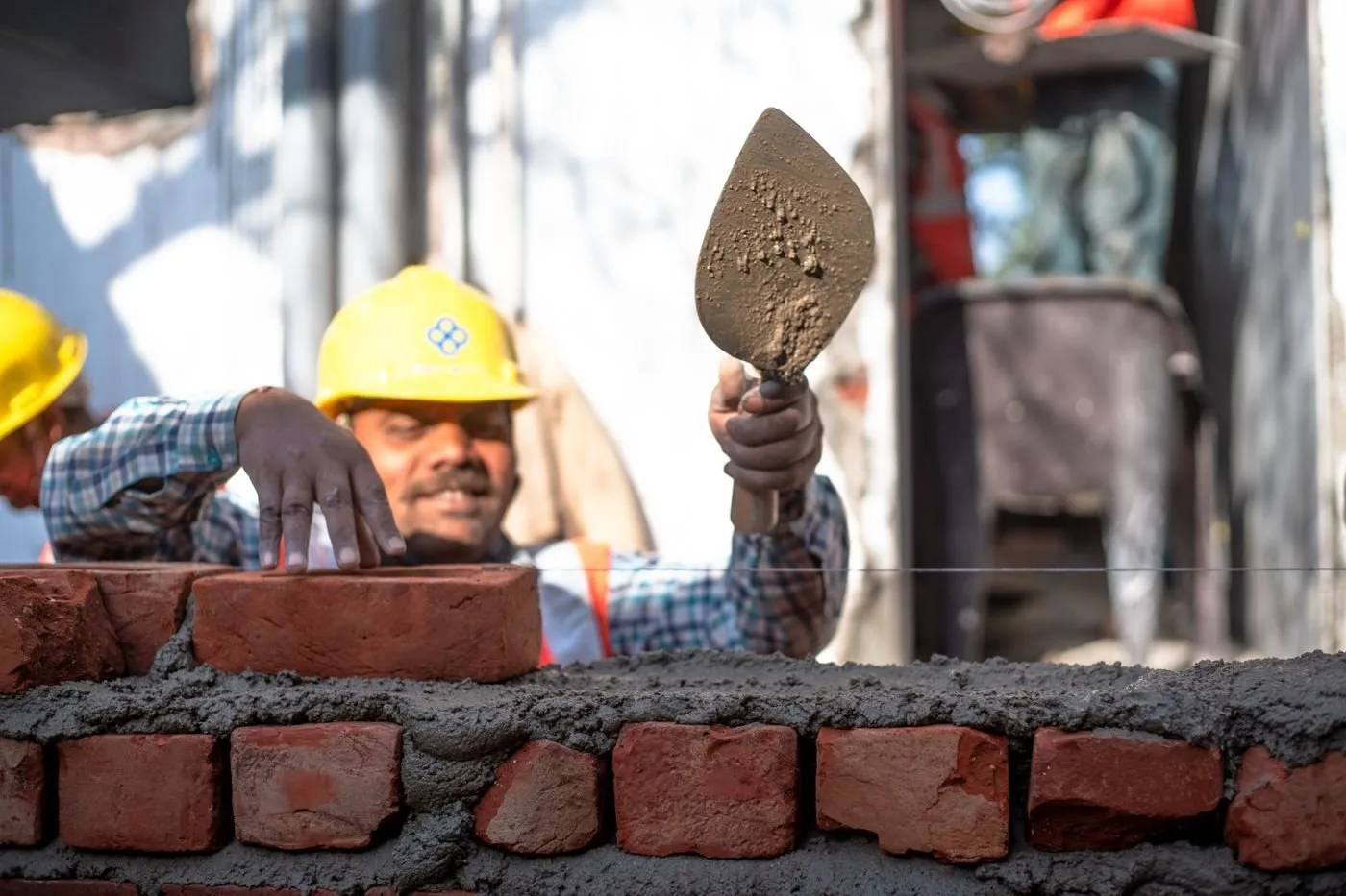Skilled mason laying bricks